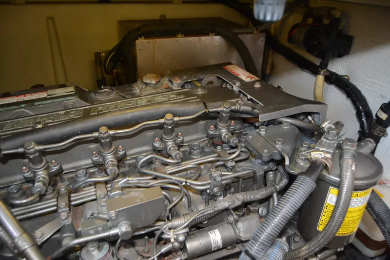 Slide: The Image of Engine compartment of a 2005 Sabre 38 Express boat, showcasing detailed mechanical components. - 105