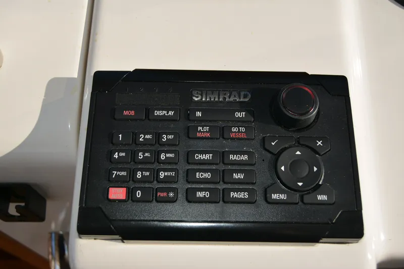 Slide: The Image of Simrad marine navigation control panel on 2005 Sabre 38 Express boat. - 44
