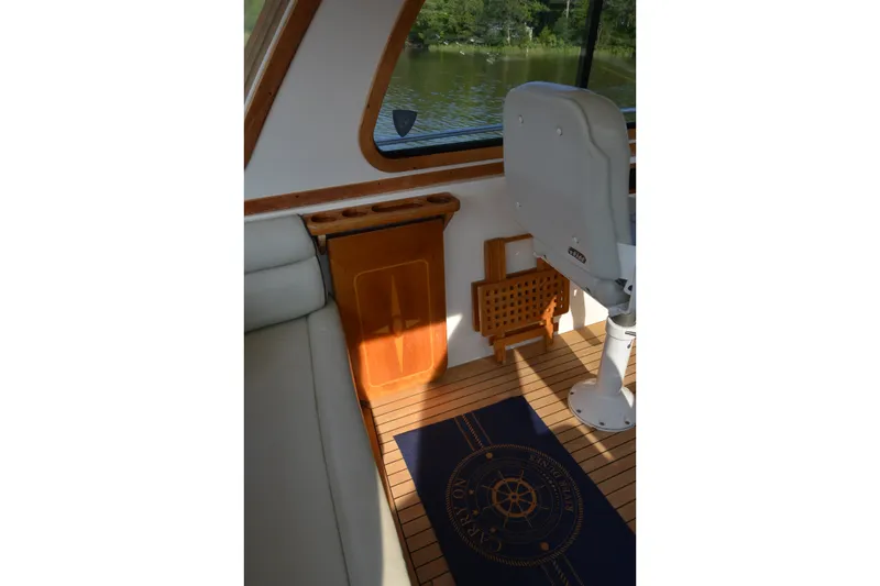 Slide: The Image of Interior of 2005 Sabre 38 Express boat with wooden flooring and seating. - 38