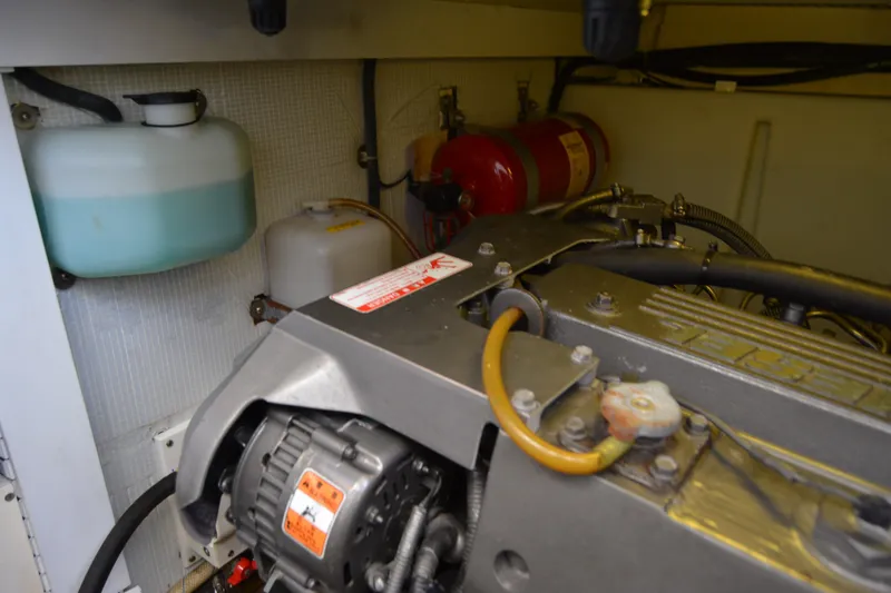 Slide: The Image of Engine compartment of a 2005 Sabre 38 Express boat, featuring various components and hoses. - 109