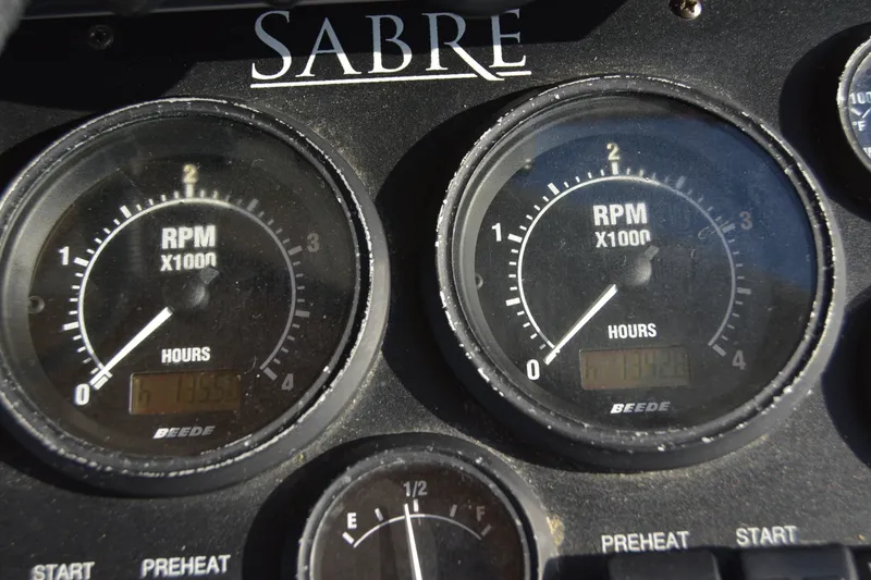 Slide: The Image of 2005 Sabre 38 Express dashboard with RPM gauges and hour meters. - 49