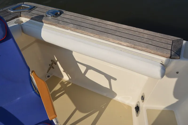Slide: The Image of 2005 Sabre 38 Express boat interior with wooden trim and blue seating. - 29