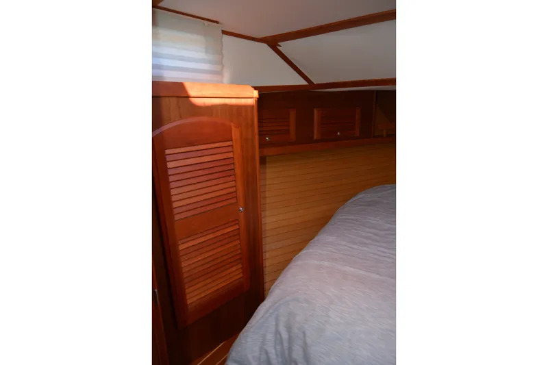 Slide: The Image of Interior cabin of 2005 Sabre 38 Express yacht with wooden cabinetry and bed. - 83