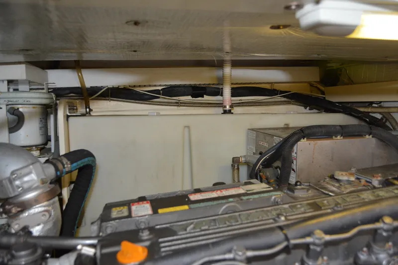 Slide: The Image of Engine room of a 2005 Sabre 38 Express boat, showcasing mechanical components and wiring. - 106