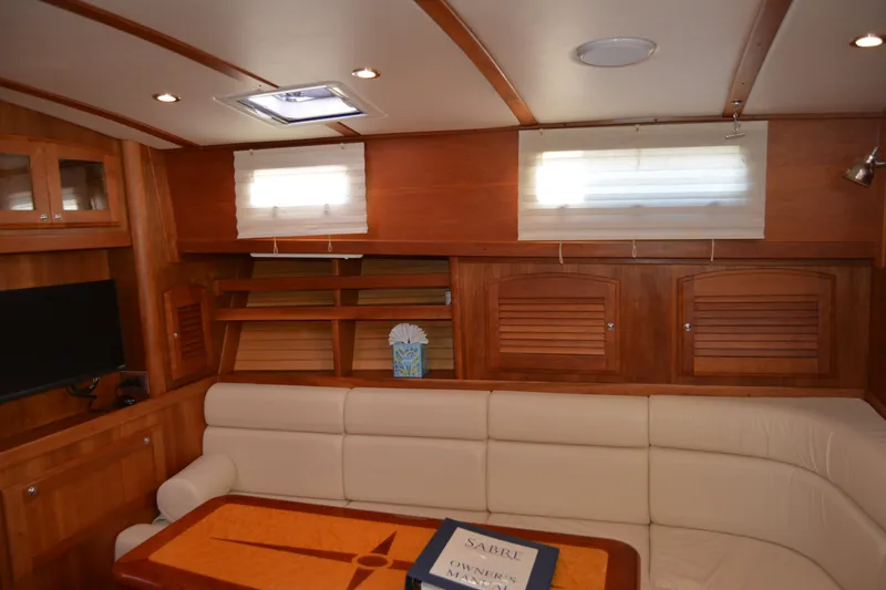 Slide: The Image of Interior of 2005 Sabre 38 Express yacht with wood paneling and beige seating. - 72