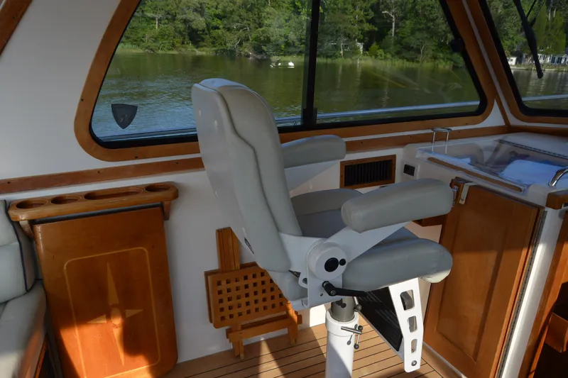 Slide: The Image of Interior of 2005 Sabre 38 Express boat with captain's chair and wooden accents. - 54