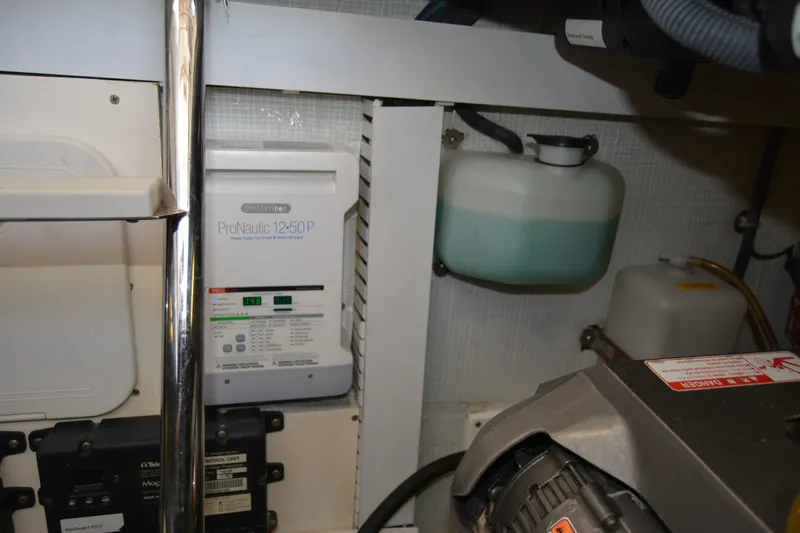 Slide: The Image of Engine room of 2005 Sabre 38 Express with ProNautic 12-50P charger and fluid reservoirs. - 101