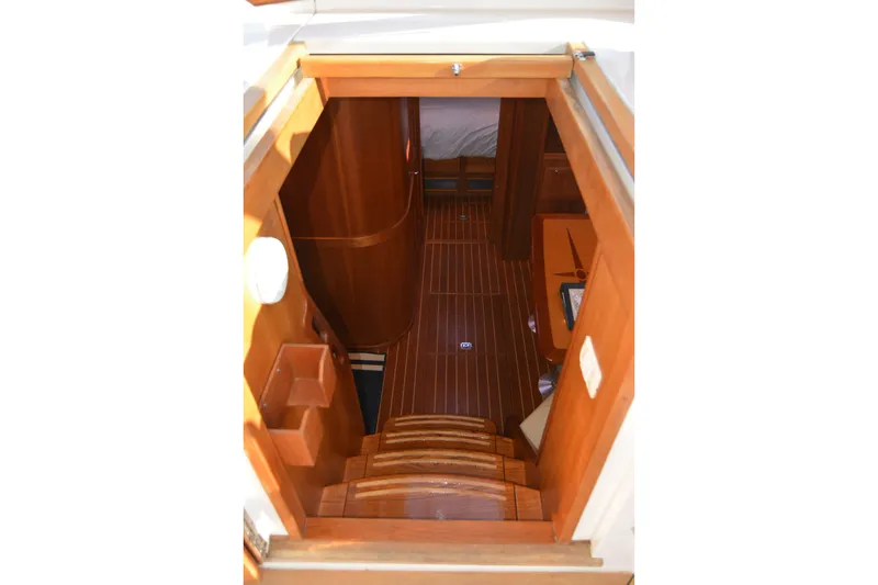 Slide: The Image of Interior view of 2005 Sabre 38 Express yacht, showcasing wooden stairs and cabin entrance. - 58