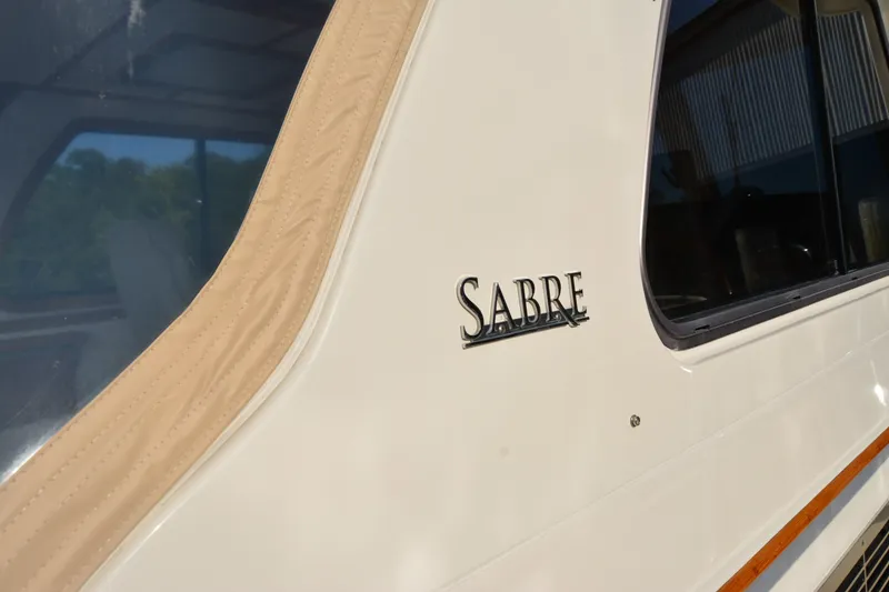 Slide: The Image of 2005 Sabre 38 Express boat side view with logo and window detail. - 23