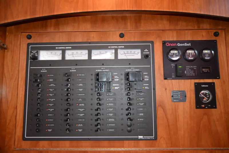 Slide: The Image of Electrical control panel on a 2005 Sabre 38 Express boat, featuring Onan GenSet gauges. - 77