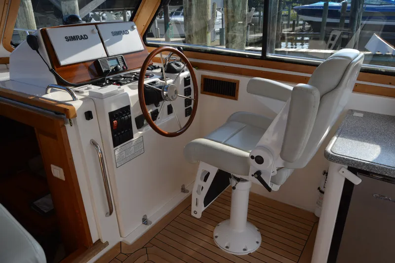 Slide: The Image of Helm of 2005 Sabre 38 Express boat with Simrad navigation system and captain's chair. - 52
