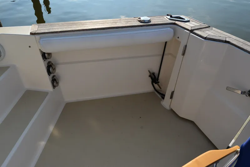 Slide: The Image of 2005 Sabre 38 Express boat interior with wooden trim and seating area. - 27