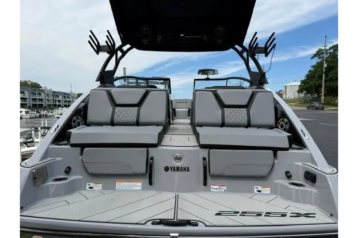 Slide: The Image of 2026 Yamaha Boats 255XD, sleek design, spacious seating, modern features, docked at marina. - 36