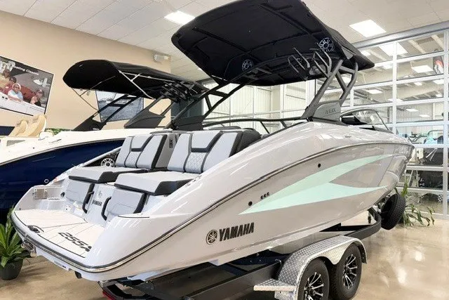 Slide: The Image of 2026 Yamaha Boats 255XD in showroom, sleek design, dual engines, modern features. - 1