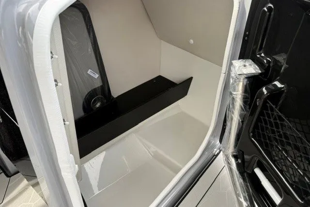 Slide: The Image of Interior storage compartment of 2026 Yamaha Boats 255XD, featuring sleek design and ample space. - 34
