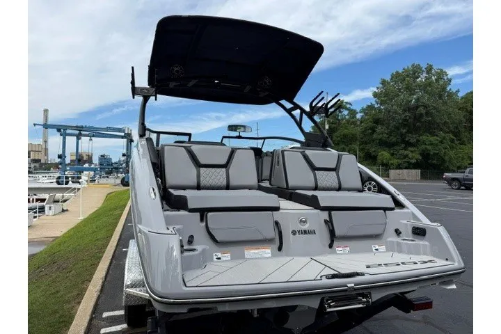 Slide: The Image of 2026 Yamaha Boats 255XD with sleek design, docked in a marina setting. - 23