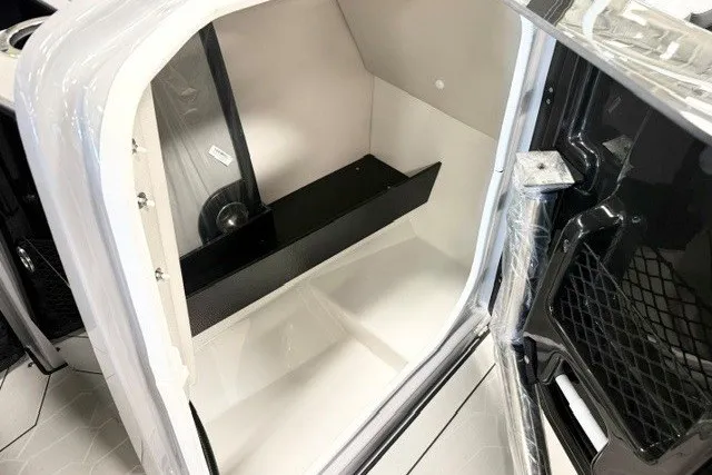 Slide: The Image of 2026 Yamaha Boats 255XD interior storage compartment, showcasing sleek design and ample space. - 13
