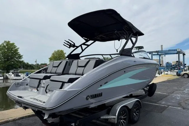 Slide: The Image of 2026 Yamaha Boats 255XD on trailer, sleek design, dockside view. - 22