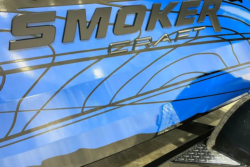 Slide: The Image of 2026 Smoker Craft Excursion 166 SC boat with sleek blue design and bold lettering. - 3