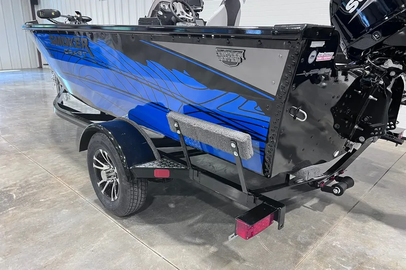 Slide: The Image of 2026 Smoker Craft Excursion 166 SC boat on trailer, featuring sleek blue and black design. - 6