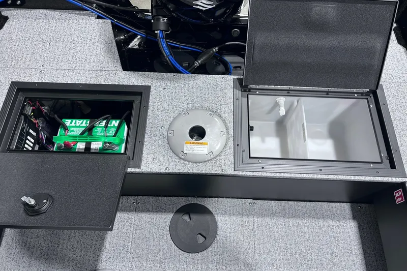 Slide: The Image of 2026 Smoker Craft Excursion 166 SC boat compartments with battery and storage. - 14