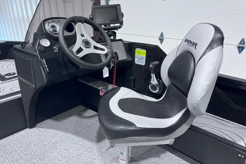 Slide: The Image of 2026 Smoker Craft Excursion 166 SC boat interior with steering console and cushioned seat. - 11
