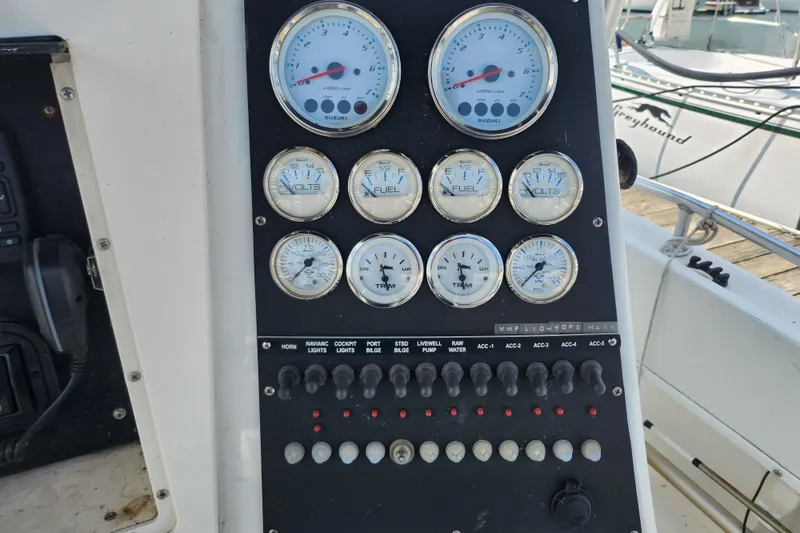 Slide: The Image of Control panel of a 1999 World Cat 246 SF boat with gauges and switches. - 15
