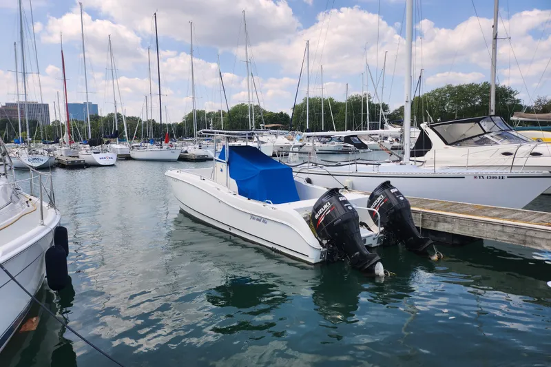 Slide: The Image of 1999 World Cat 246 SF boat docked in a marina with other sailboats. - 2
