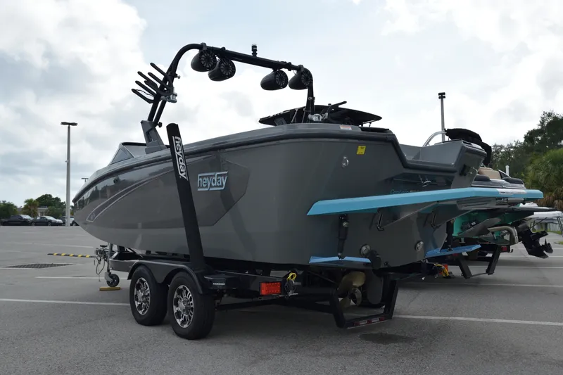 Slide: The Image of 2019 Heyday WT-2 boat on trailer, parked outdoors, showcasing sleek design and modern features. - 12