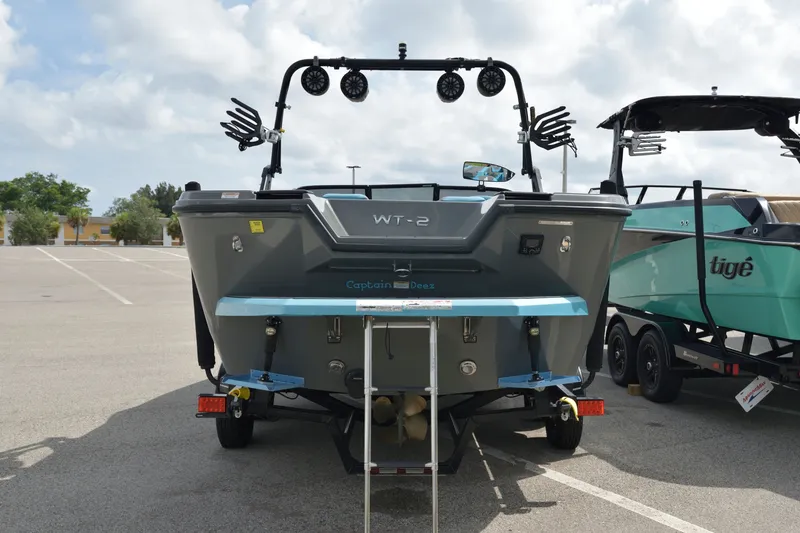 Slide: The Image of 2019 Heyday WT-2 boat in parking lot, rear view with wakeboard racks and speakers. - 14