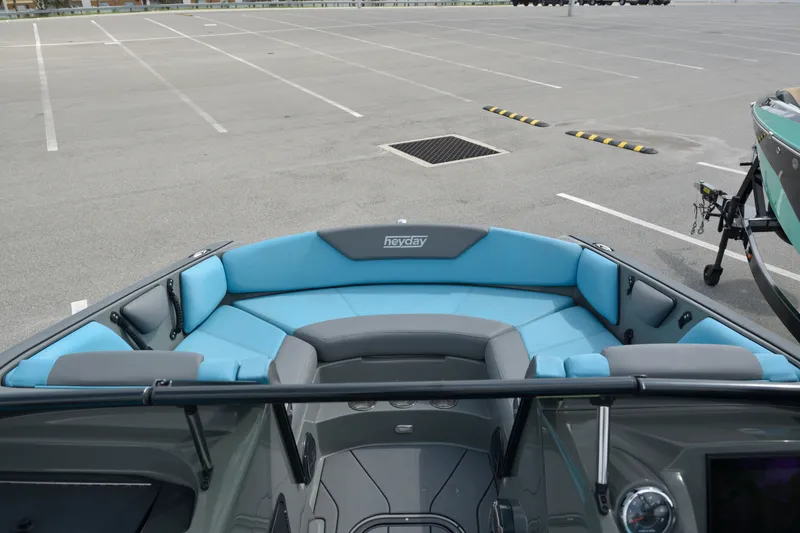 Slide: The Image of 2019 Heyday WT-2 boat with blue seating in an empty parking lot. - 23