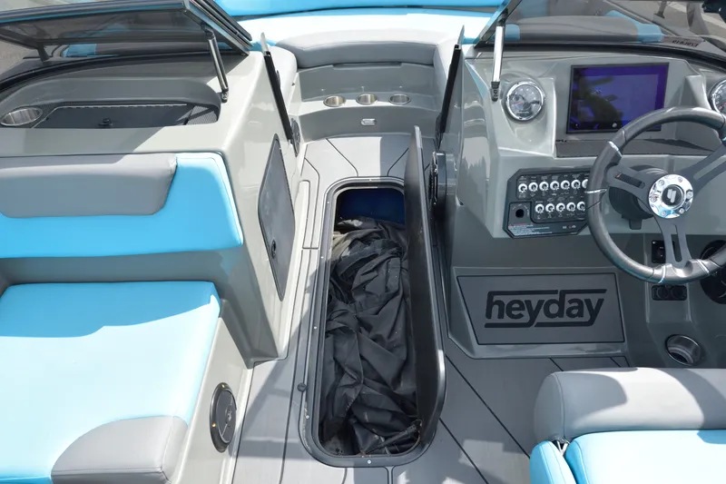 Slide: The Image of 2019 Heyday WT-2 boat interior with blue seating and modern dashboard controls. - 19