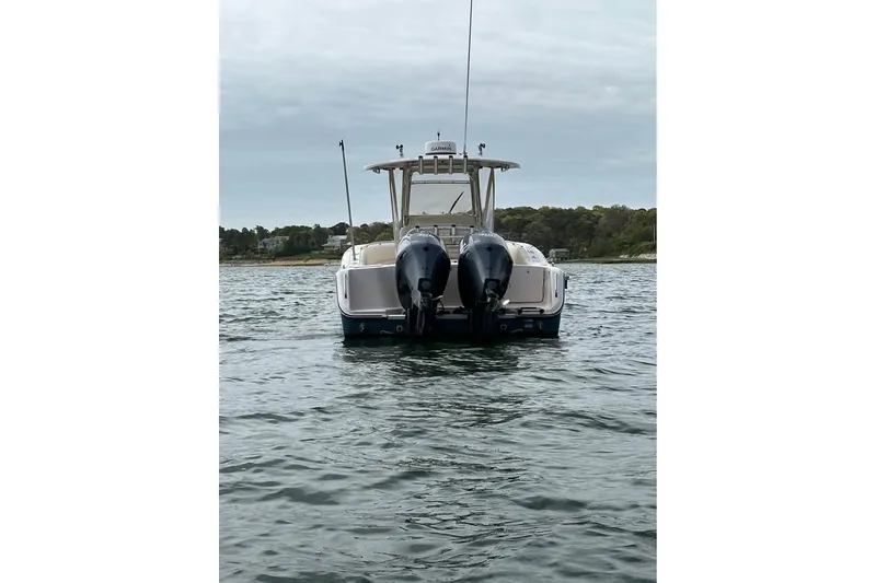 Slide: The Image of 2013 Grady-White Canyon 271 boat with dual outboard motors on water. - 5