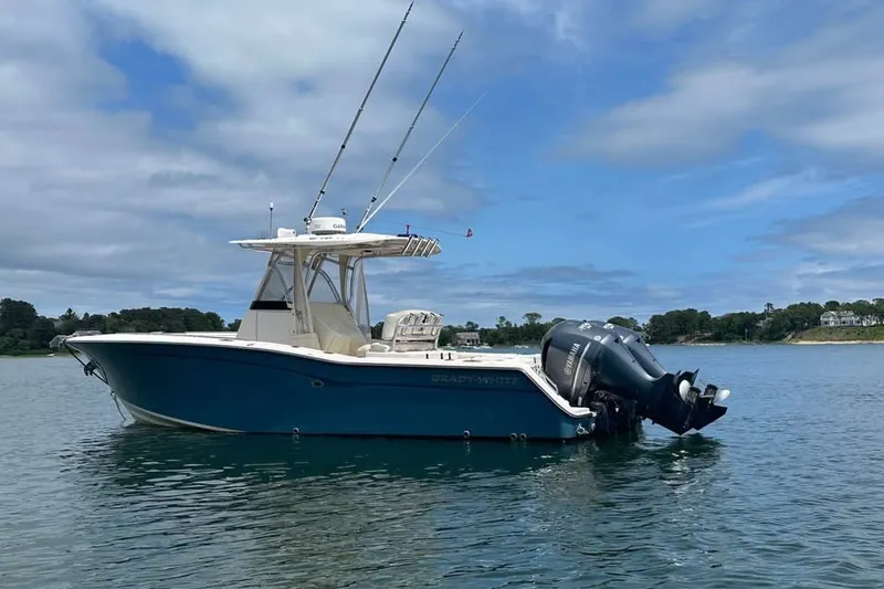 Slide: The Image of 2013 Grady-White Canyon 271 boat on calm water under blue sky. - 3
