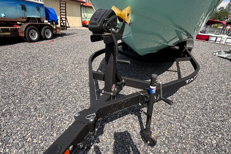 Slide: The Image of Trailer hitch of a 2026 Tahoe T21 boat on gravel lot. - 7