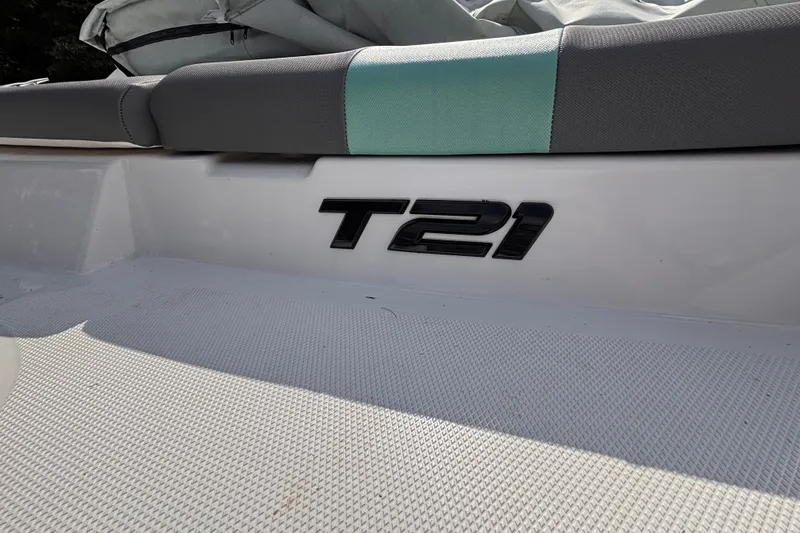 Slide: The Image of 2026 Tahoe T21 boat interior with logo and cushioned seating. - 9