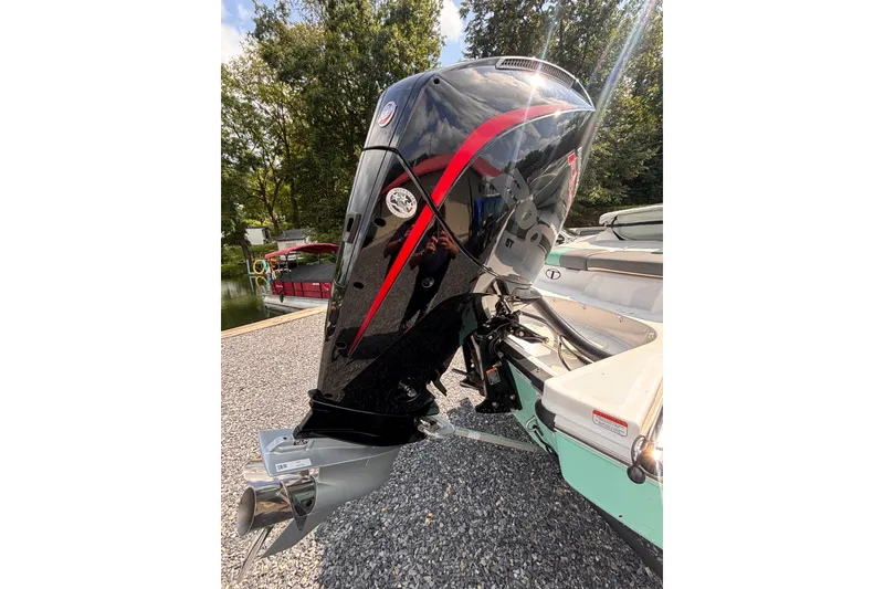 Slide: The Image of 2026 Tahoe T21 boat engine with sleek black and red design, docked outdoors. - 8