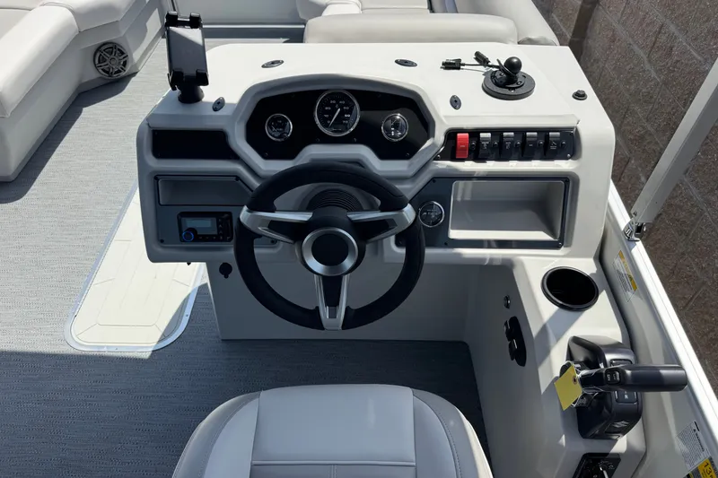 Slide: The Image of 2027 Godfrey Xperience 2286 Flip Lounge boat dashboard with steering wheel and controls. - 13