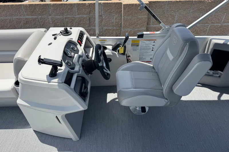 Slide: The Image of 2027 Godfrey Xperience 2286 Flip Lounge boat interior with steering console and captain's chair. - 9