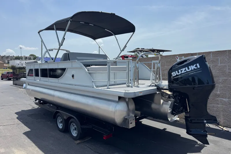 Slide: The Image of 2027 Godfrey Xperience 23' Lounger pontoon boat with Suzuki outboard motor on trailer. - 2