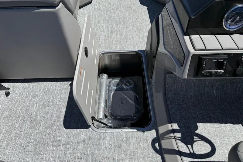 Slide: The Image of Open storage compartment on 2026 Premier 230 Sunsation RL boat interior. - 28