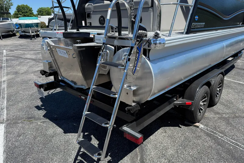 Slide: The Image of 2026 Premier 230 Sunsation RL pontoon boat on trailer with ladder and dual axles. - 9