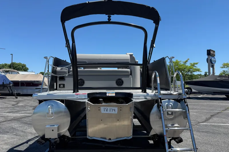 Slide: The Image of Rear view of 2026 Premier 230 Sunsation RL pontoon boat in a parking lot. - 10