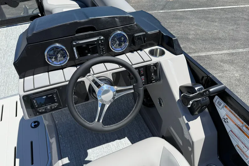Slide: The Image of 2026 Premier 230 Sunsation RL boat dashboard with steering wheel and control panel. - 21