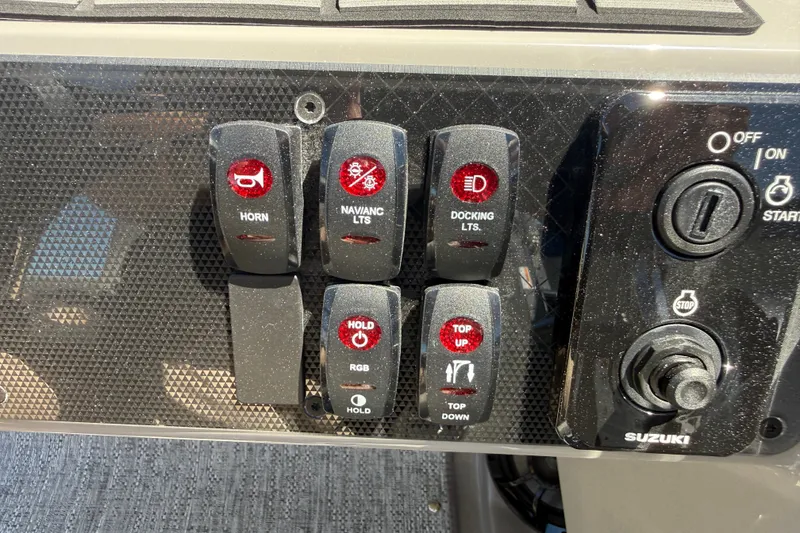Slide: The Image of Control panel of 2026 Premier 230 Sunsation RL boat with labeled switches and ignition. - 25