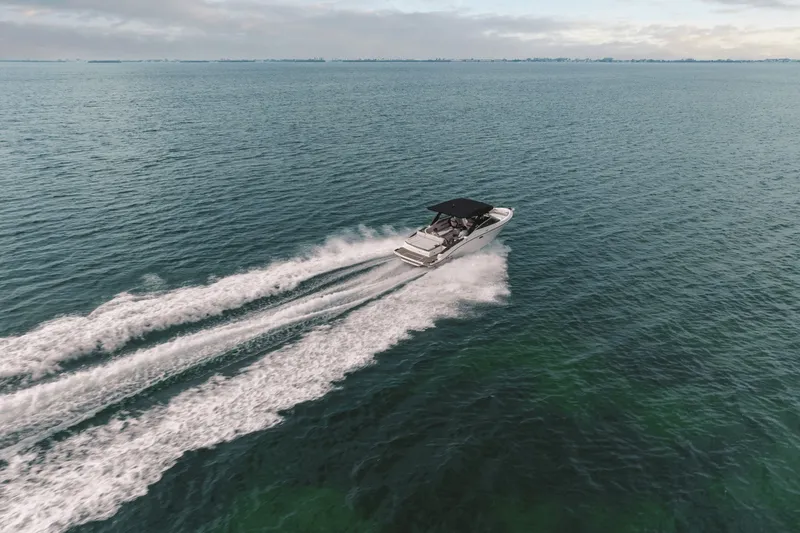 Slide: The Image of A 2027 Sea Ray SLX 280 speeds across open water, featuring a sleek design and black canopy. - 37