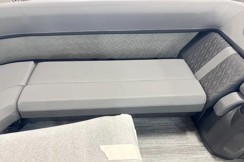 Slide: The Image of 2027 Bennington 24 M Open Fastback Quad Bench with sleek gray upholstery and diamond-patterned accents. - 9