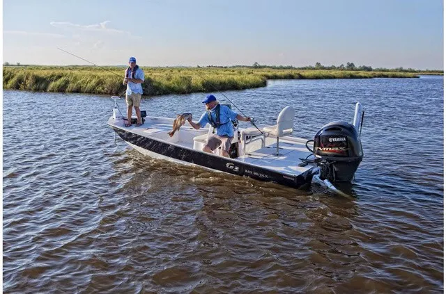 The Image of Two people fishing on a G3 Bay 20 DLX boat in the water. - 1