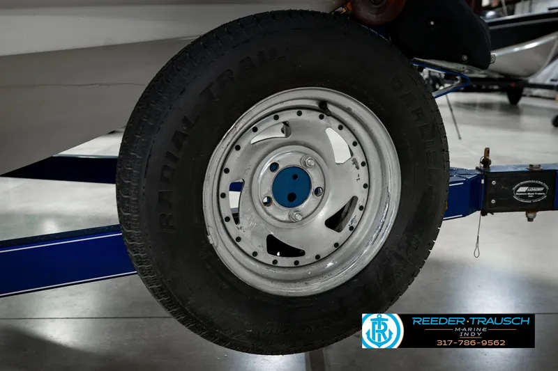 Slide: The Image of Trailer wheel of a 2007 Larson LXi 228 Wakeboard Edition boat, featuring a radial tire. - 60
