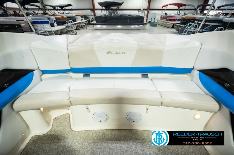 Slide: The Image of 2007 Larson LXi 228 Wakeboard Edition boat interior with white and blue seating. - 25